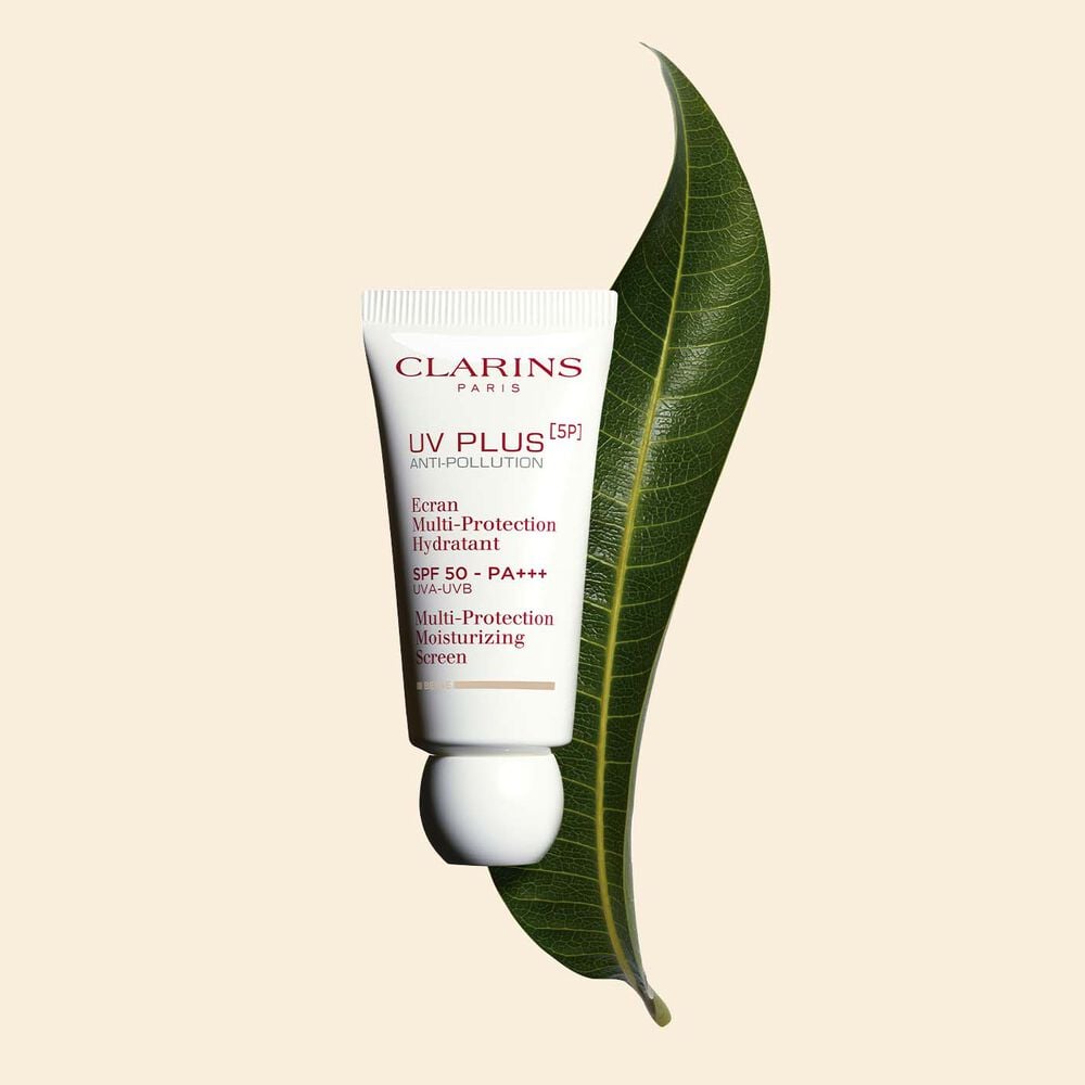 Packshot of a tube of Clarins UV Plus Anti-Pollution Beige a Moisturising Fluid with SPF 50 on a yellow background.