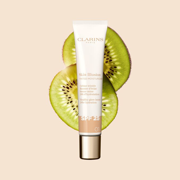 Packshot of the 40ml tube of Skin perfector Skin Illusion Tinted Moisturiser shade 01, placed next to kiwi slides