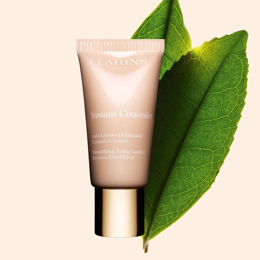 Clarins Instant Concealer showcasing its packshot in front of white tea leave.