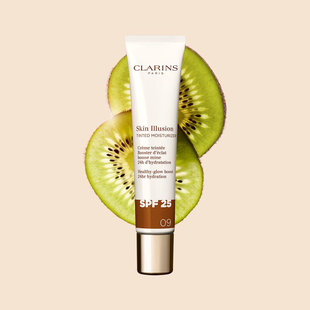 Packshot of the 40ml tube of Skin perfector Skin Illusion Tinted Moisturiser shade 09 placed next to kiwi slides