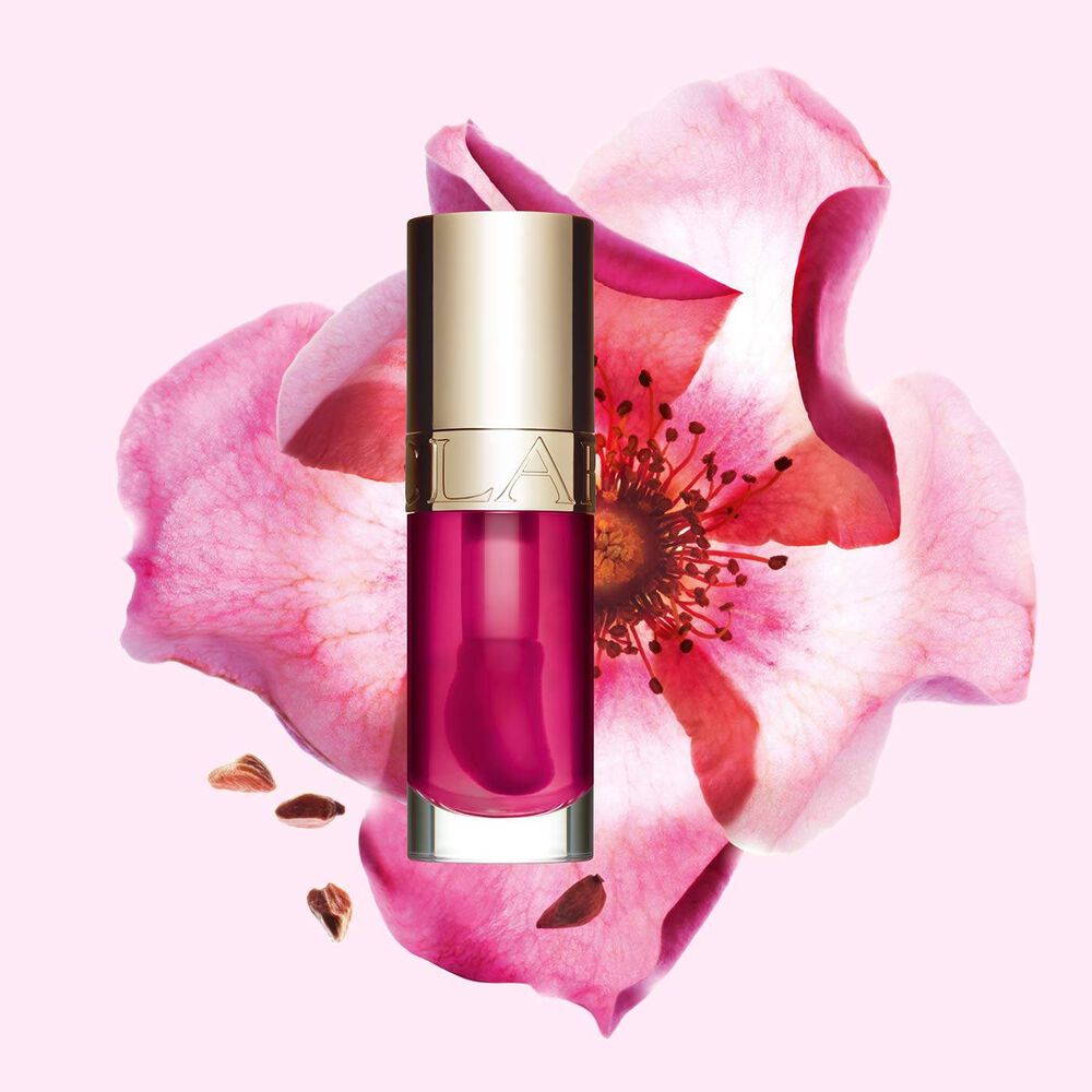 Packshot of Clarins Lip Comfort Oil 02 Raspberry with a Sweetbriar rose, showcasing its natural ingredient skincare formula.