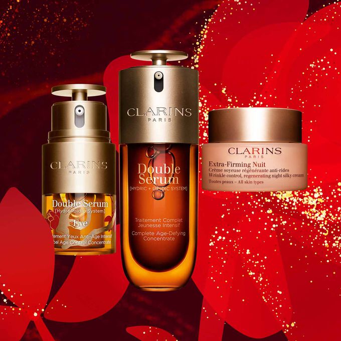 Clarins daily skincare products, featuring the Eye Double Serum Limited Edition, Double Serum, and Extra-Firming Night Care.