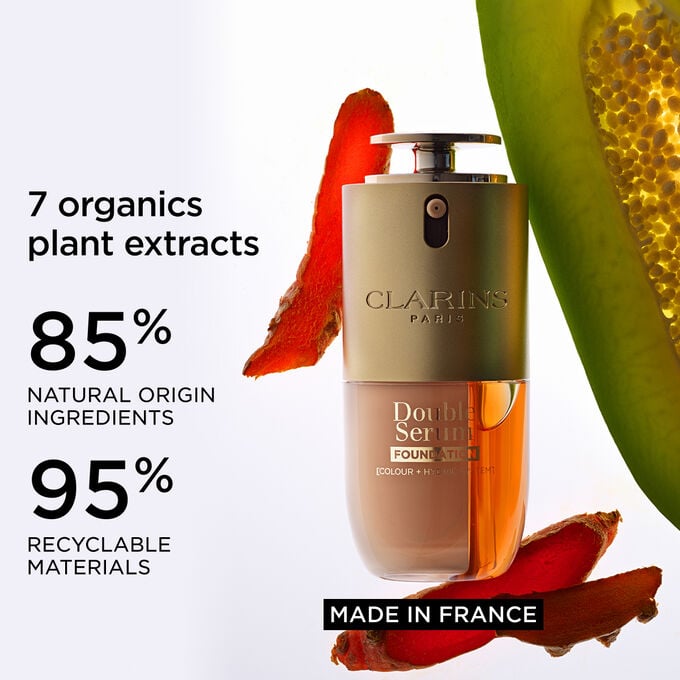 Packshot of Double Serum Foundation close to turmeric and papain, highlighting natural ingredients and Made in France label