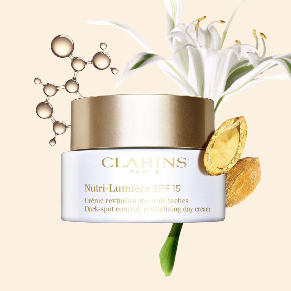  Packshot of the Nutri-Lumière SPF15 anti-blemish cream alongside niacinamide molecule, sea lily plant and desert date.
