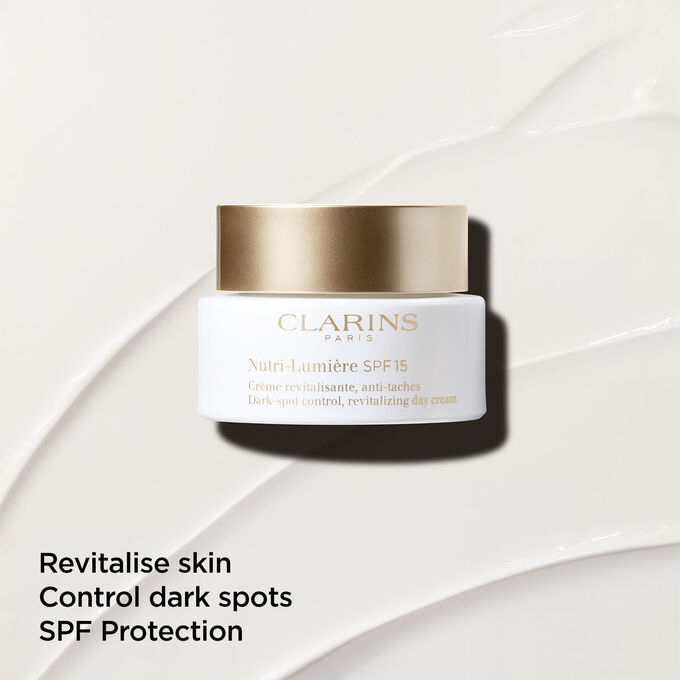 Anti-dark spot day cream with SPF15 on a textured background, emphasising its skin revitalising action.