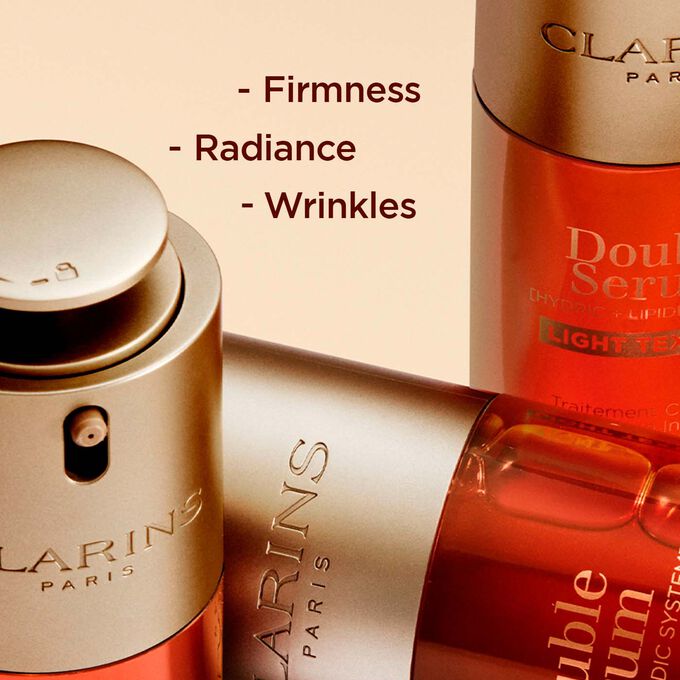 Close-up of Clarins Double Serum Light Texture bottles, highlighting enhanced firmness, radiance and reduced wrinkles.