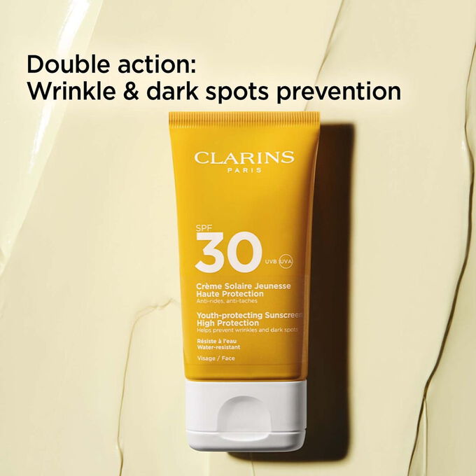 Packshot on textured background of anti-age cream 30+ tube with text about its anti-wrinkles and dark spots prevention actions