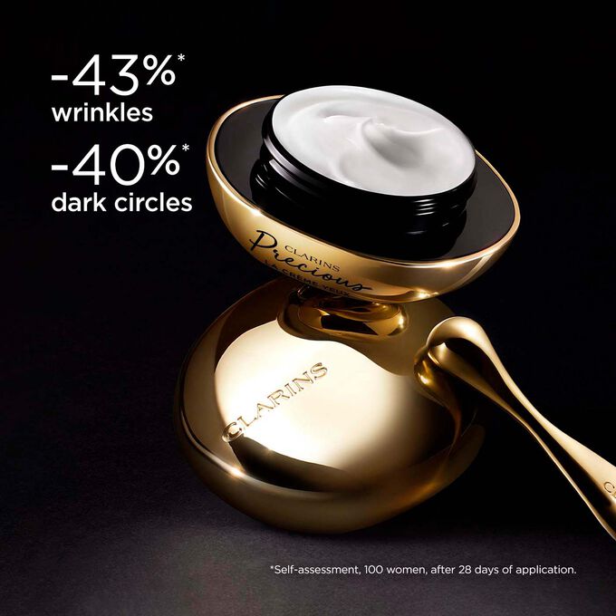 Clarins Precious Eyes eye cream on dark background, with text emphasising its power to make skin appear 5 years younger