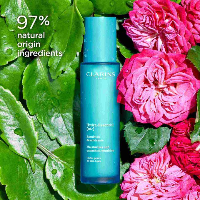 Packshot of Clarins Hydra-Essentiel 23 Emulsion among Damascus roses, highlighting its 97% natural origin ingredients.