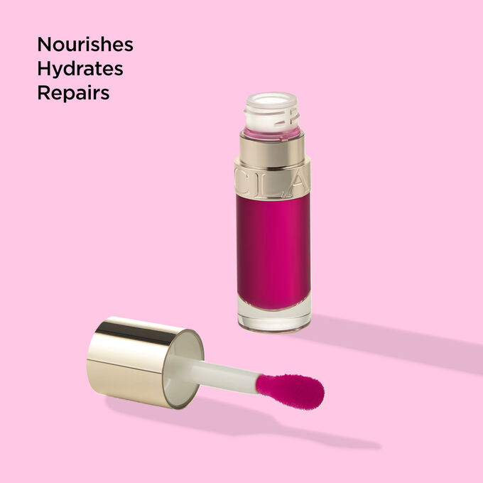 Packshot of Clarins Lip Comfort Oil 02 Raspberry with text emphasising its nourishing, hydrating and repairing benefits.