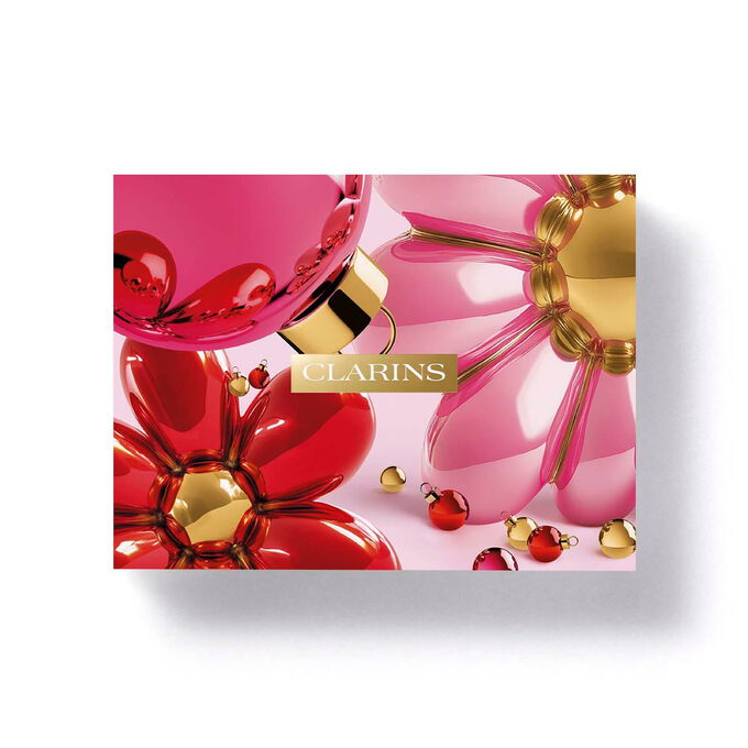 Clarins floral eco designed gift box packaging featuring vibrant pink flowers for a nourishing body care gift set.