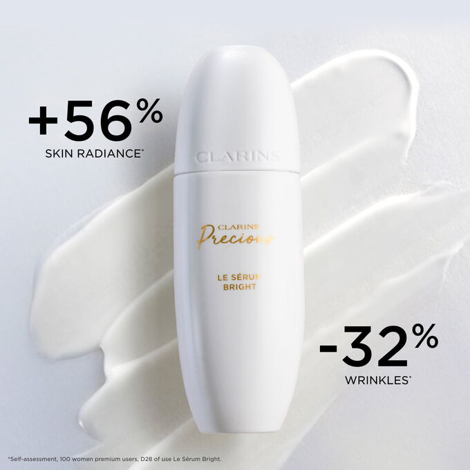 Packshot of Clarins Precious Brightening Serum on a textured background, highlighting its effect on skin radiance and wrinkle reduction.
