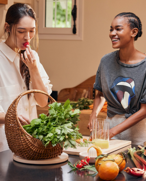 Two women preparing fruit