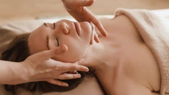 a female receiving a neck massage a female receiving a neck massage