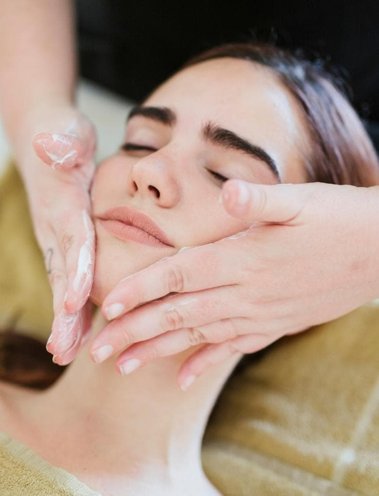 woman getting a facial massage woman getting a facial massage