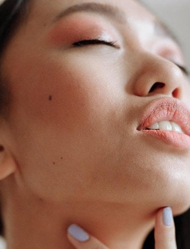 Woman wearing peach blusher Woman wearing peach blusher